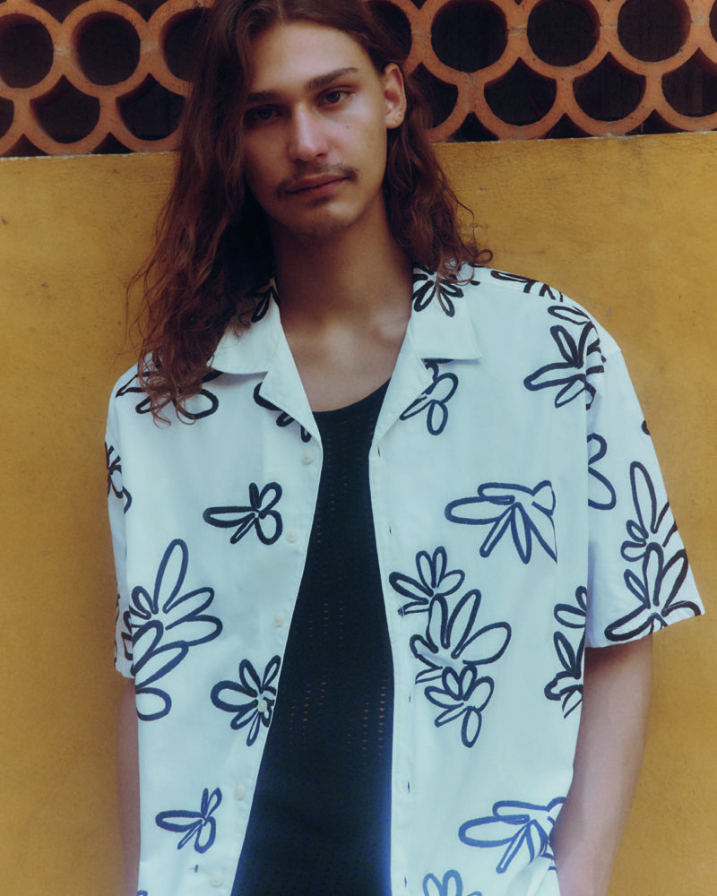 Sporting a bold floral shirt, Hudson Primo epitomizes relaxed summer fashion in Primark. 