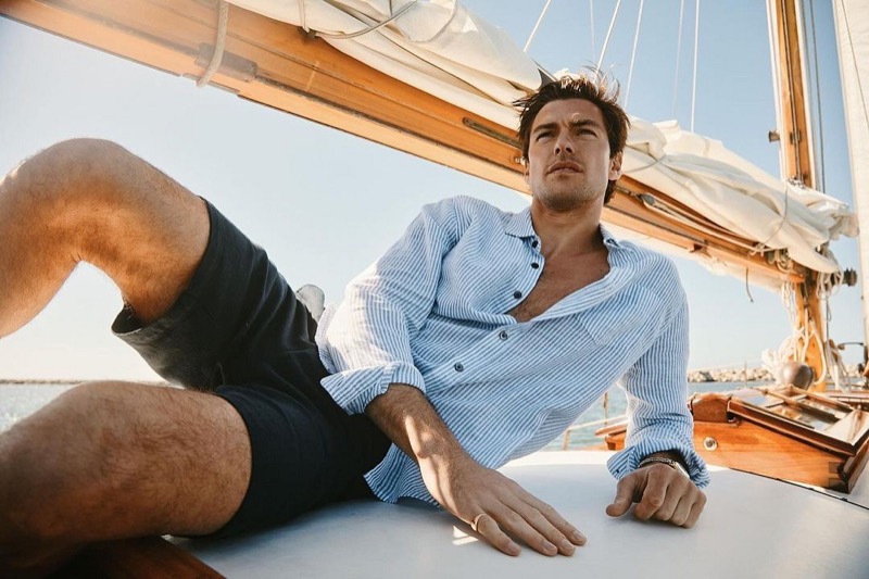 On deck, Filip Wolfe showcases a Rails light blue striped shirt paired with navy shorts. 