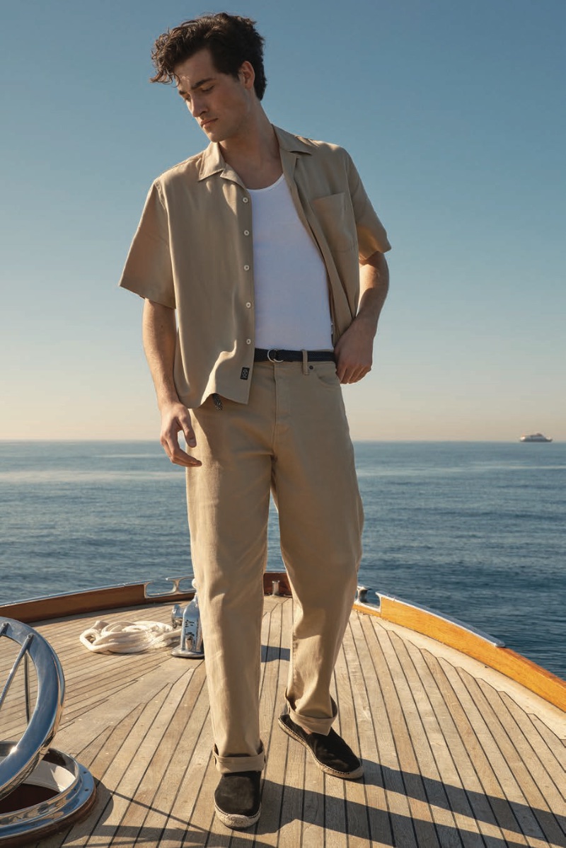 Adam Sattrup exudes casual elegance in a short-sleeve rayon Hollywood shirt over a ribbed white tank, finished with relaxed-fit 5-pocket chinos and suede espadrilles.