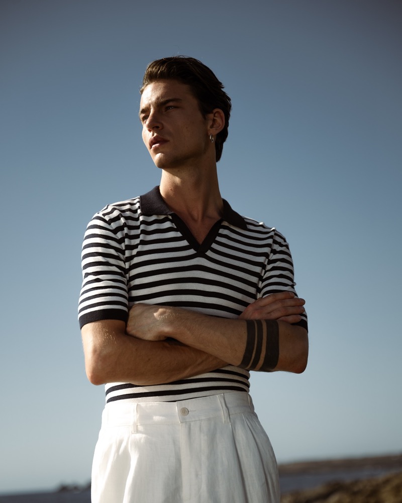 Striking a confident pose, Yulef Bopp flaunts a striped Wormland polo and white Drykorn trousers. 