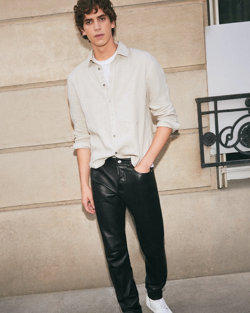 Hedi Ben Tekaya wears a light, airy shirt with statement leather pants from Zadig & Voltaire.