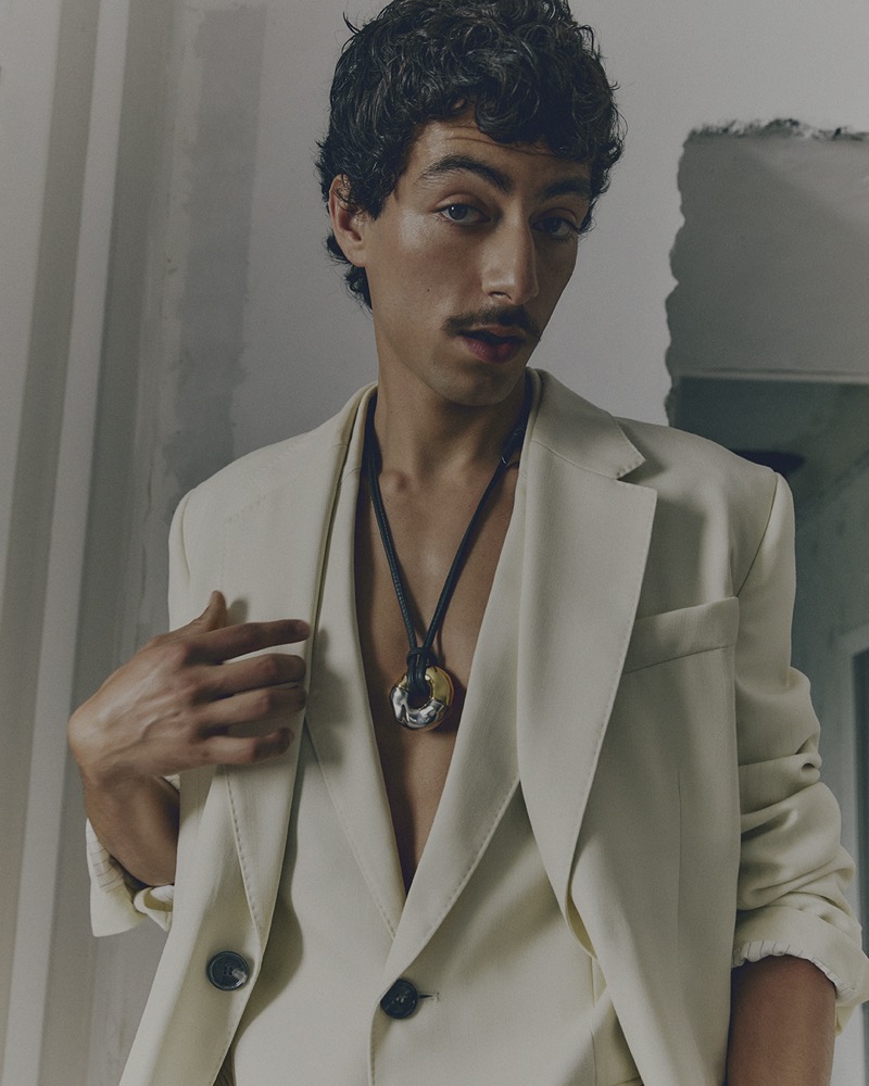 Model Elyas Polat exudes elegance in a cream blazer with a statement necklace from AMI’s spring-summer 2025 line.