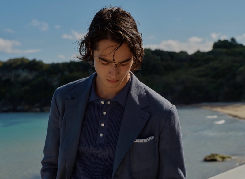 Peter Meyer models a blue blazer and knit polo, perfectly embodying Brunello Cucinelli’s high summer 2024 collection.