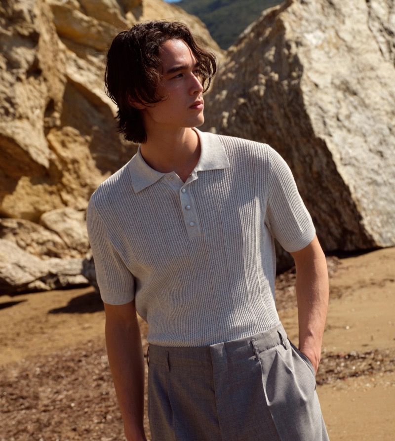 A light gray knit polo and tailored trousers, part of Brunello Cucinelli’s high summer 2024 collection, shine with refined simplicity.