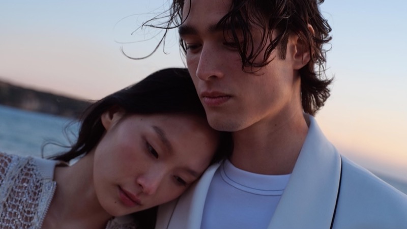 An intimate moment captured between Yoonmi Sun and Peter Meyer, highlighting Brunello Cucinelli’s delicate knitwear and relaxed tailoring for summer 2024.