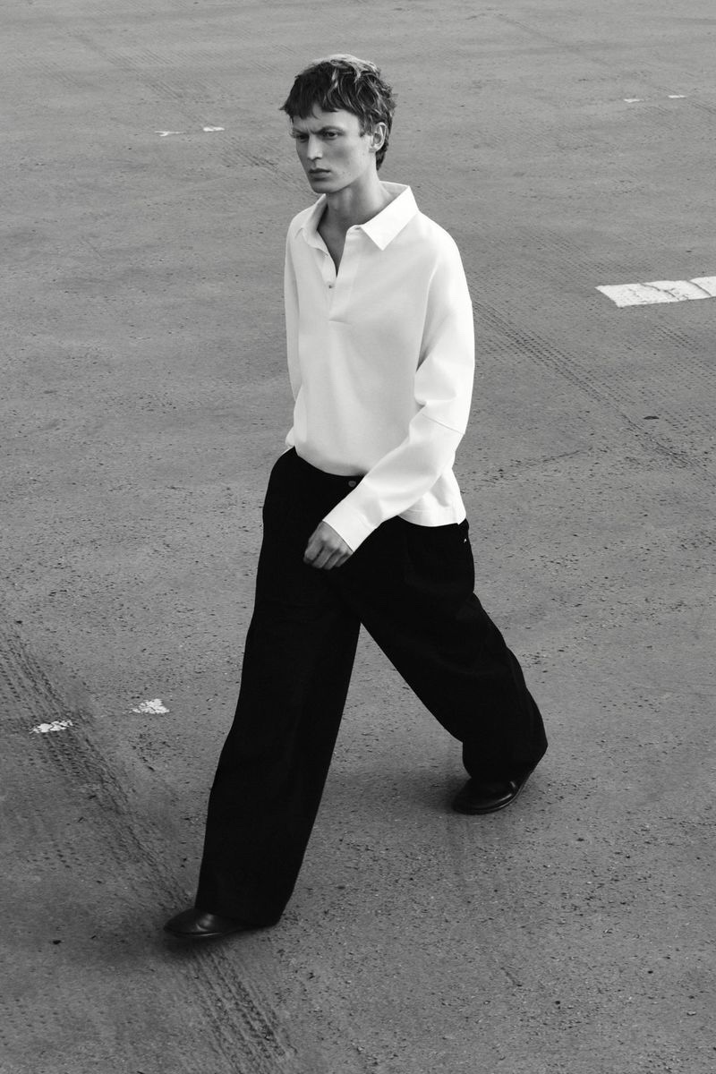 Jonas Glöer models a COS long-sleeve polo with wide-leg trousers.