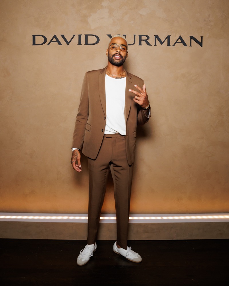 David Yurman ambassador and NBA star D’Angelo Russell dons a brown suit with white sneakers. 