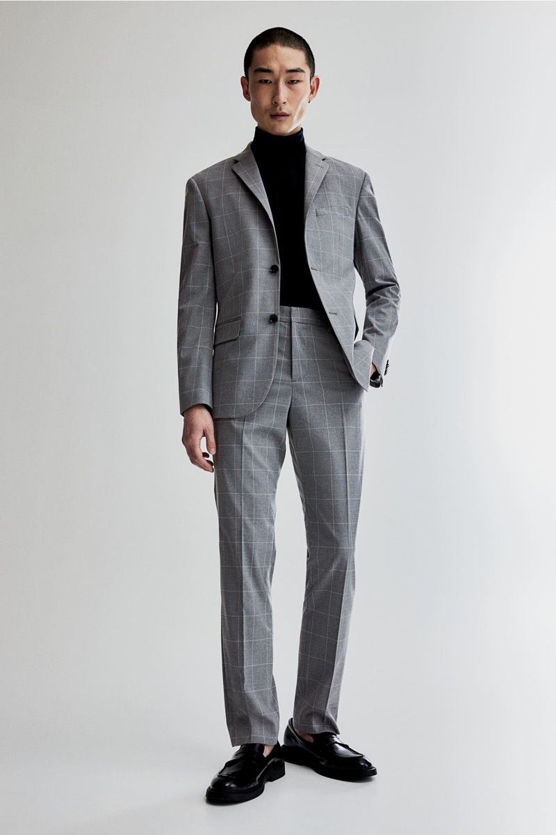 Make a bold statement with a windowpane grey suit and black turtleneck combination.