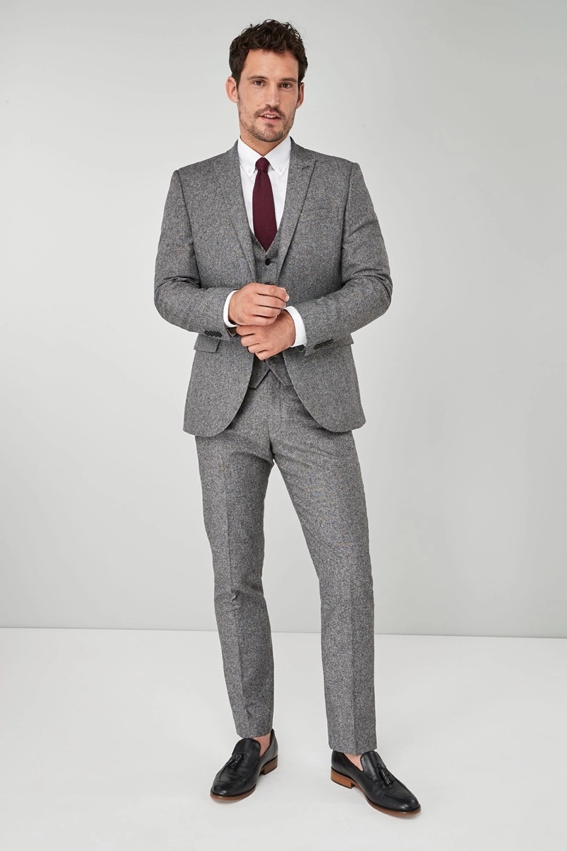 Stand out in a grey wool Donegal three-piece suit and burgundy tie for a rich, textured look.