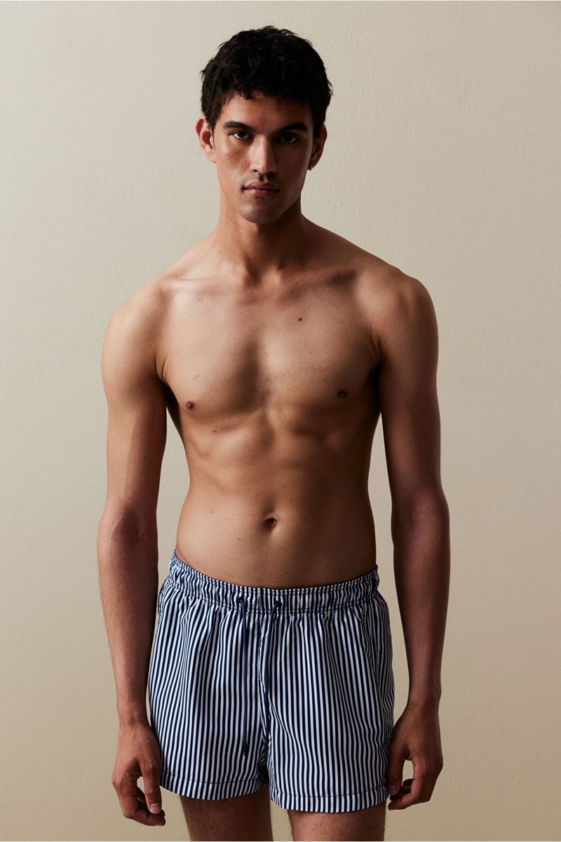 Bodhi Heeck models H&M’s dark blue striped swim shorts.