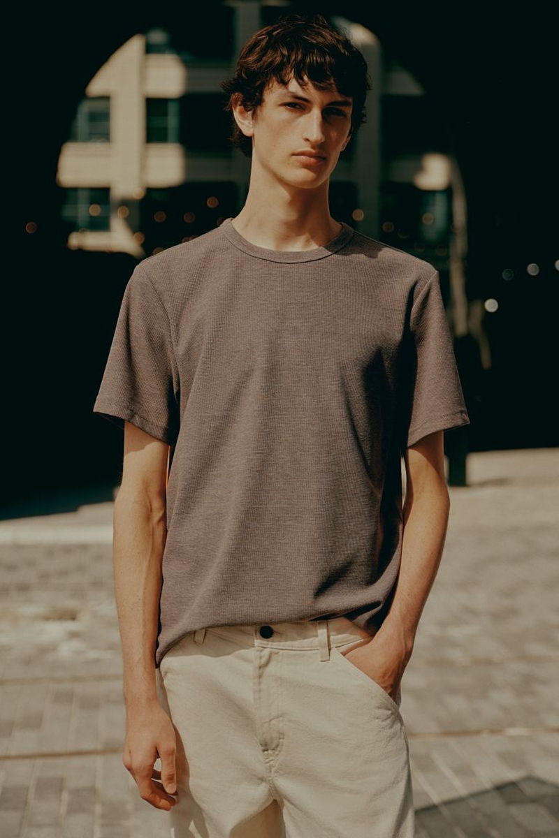 Anden Scudder showcases relaxed style in a simple grey H&M tee paired with cream pants.