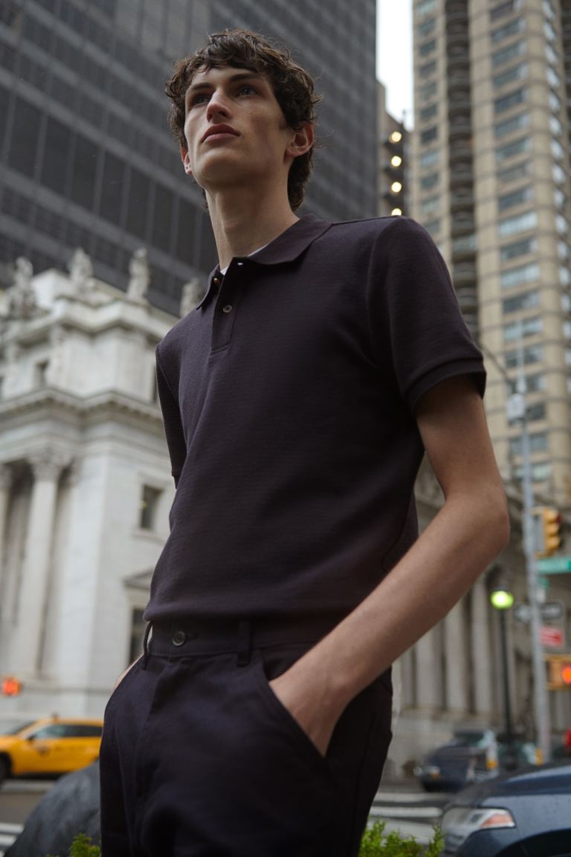 Sporting a business casual look, Anden Scudder models a black H&M polo.