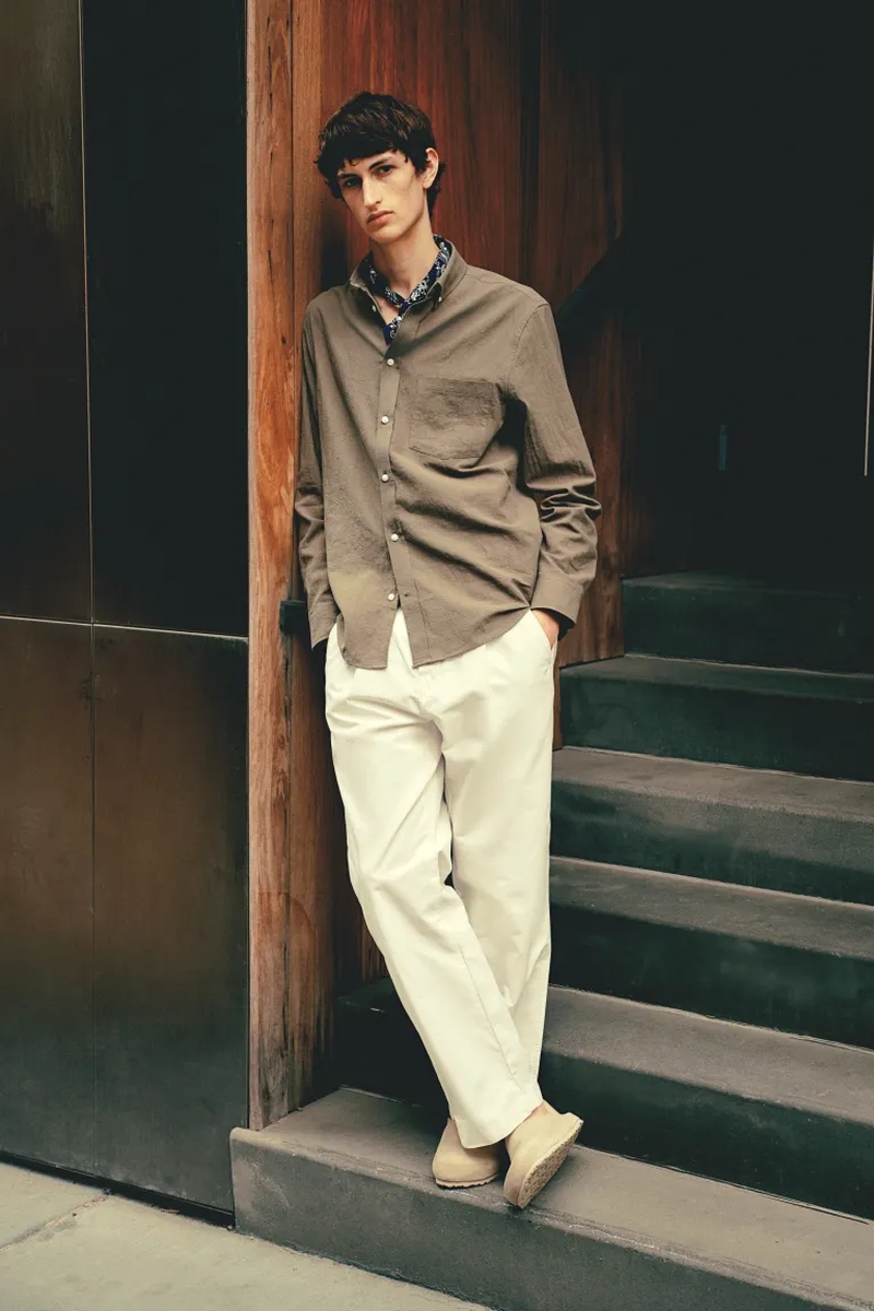 Anden Scudder wears an olive-toned shirt paired with white trousers for H&M.