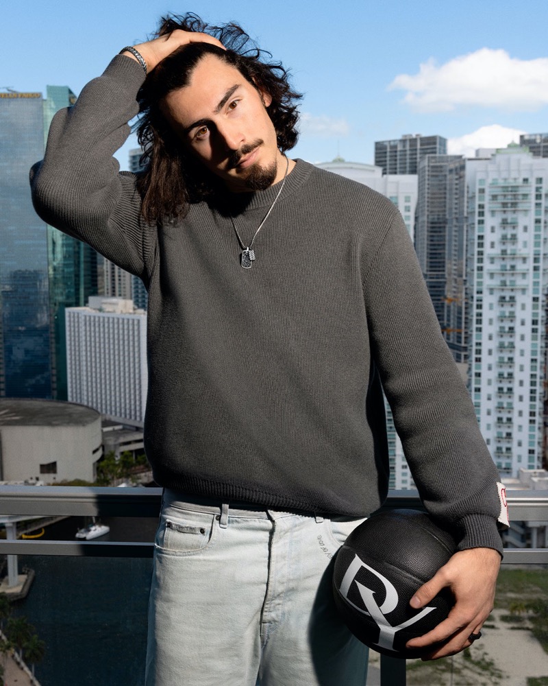 Miami Heat’s Jaime Jacquez Jr. strikes a pose against the city skyline, pairing a sleek grey sweater with David Yurman’s signature dog tag necklace.