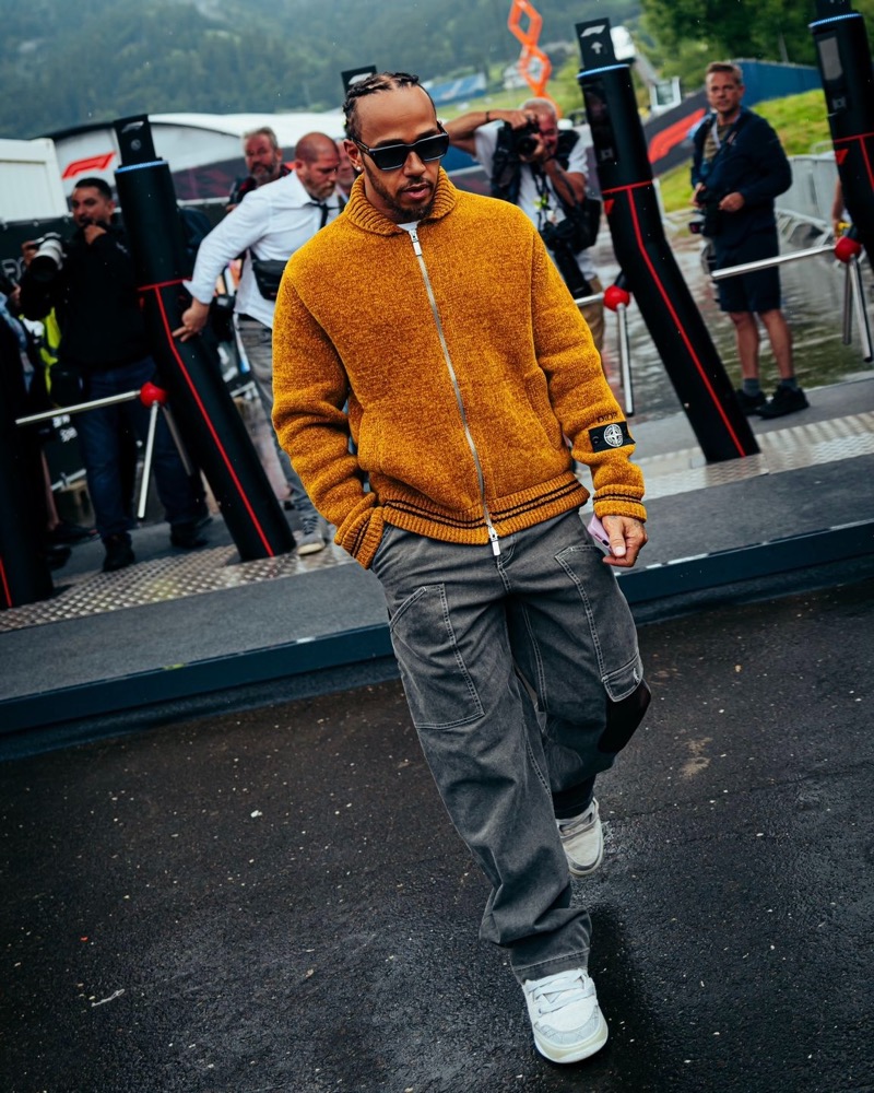 Lewis Hamilton previewed Dior Men’s Stone Island collaboration by wearing a yellow zipped blouson at the Austrian Grand Prix.