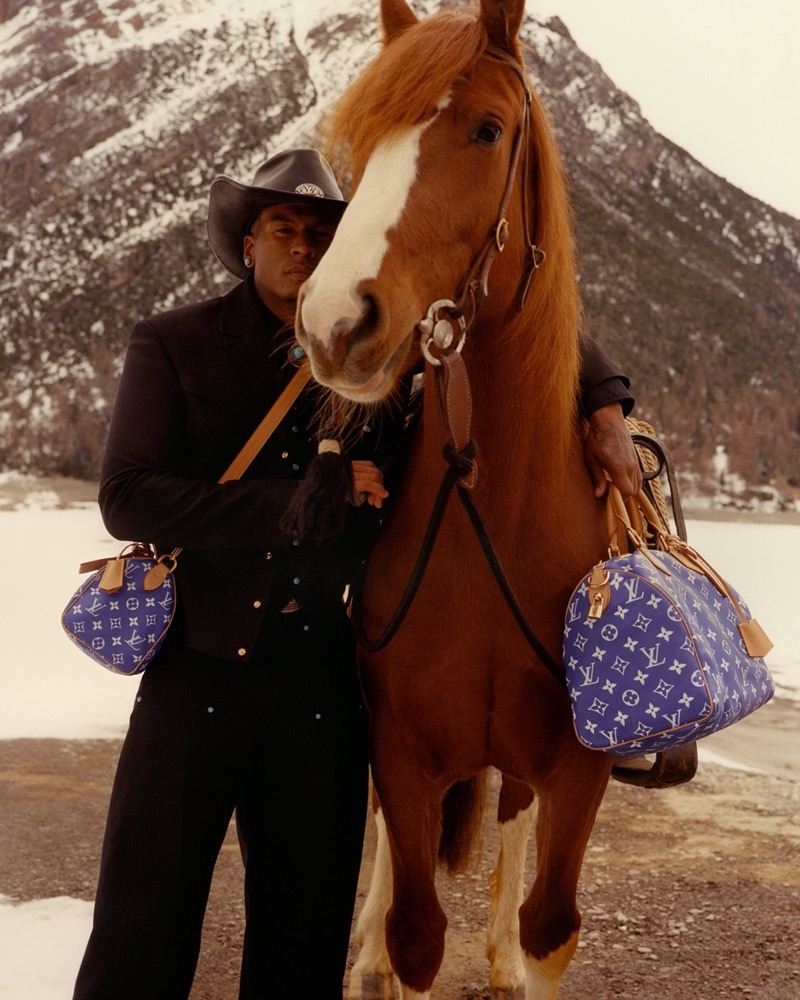 Ronnie Davis poses with a horse against a snowy backdrop for the Louis Vuitton fall-winter 2024 campaign.