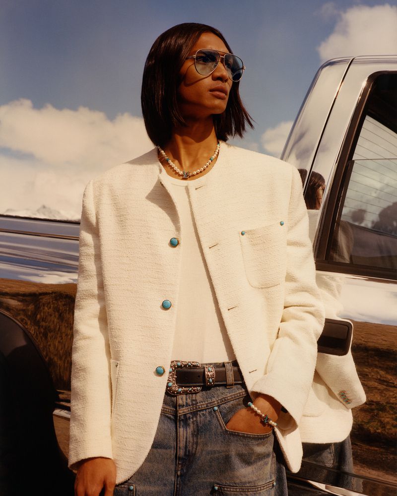 Exuding modern sophistication, Ridzman Zidaine wears a crisp white jacket and aviator sunglasses for the Louis Vuitton fall-winter 2024 campaign.