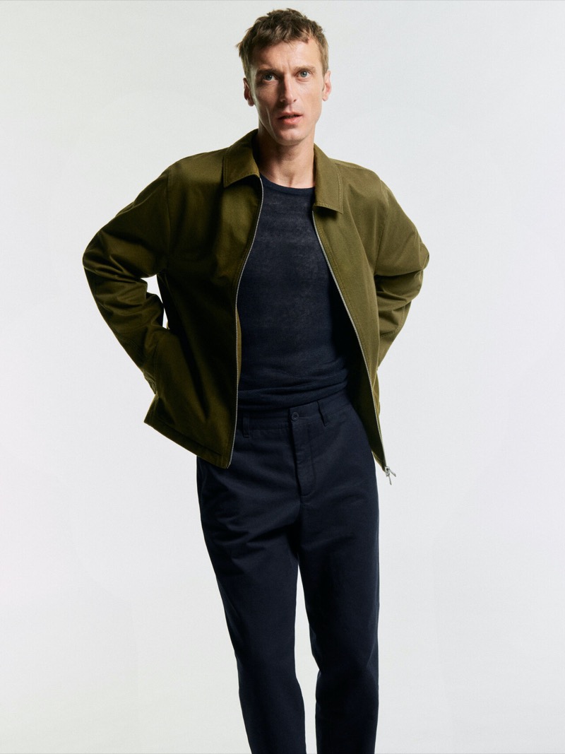 Massimo Dutti’s summer 2024 collection features Clément Chabernaud in a casual olive green jacket and black pants.