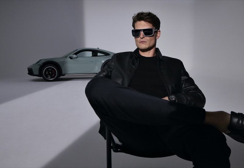 John Todd sports the Porsche Design Iconic Curved P8952 sunglasses, with a high-end Porsche adding a touch of sophistication to the scene.