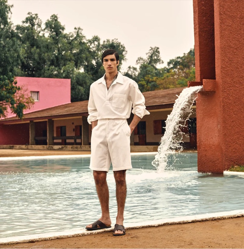 A vision in white, Duncan Yair embodies minimalist sophistication in Todd Snyder Collection’s textured long-sleeve popover shirt and relaxed shorts.