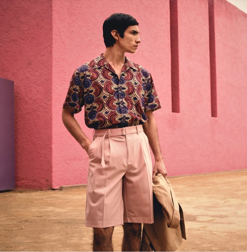 Effortlessly stylish, Duncan Yair sports a kaleidoscope camp collar shirt and pink Italian Gabardine belted shorts from Todd Snyder Collection.