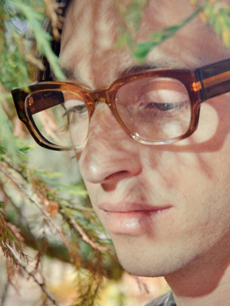 Warby Parker’s Domingo eyeglasses in Cinnamon Crystal Fade bring a warm, introspective look amidst the greenery. 