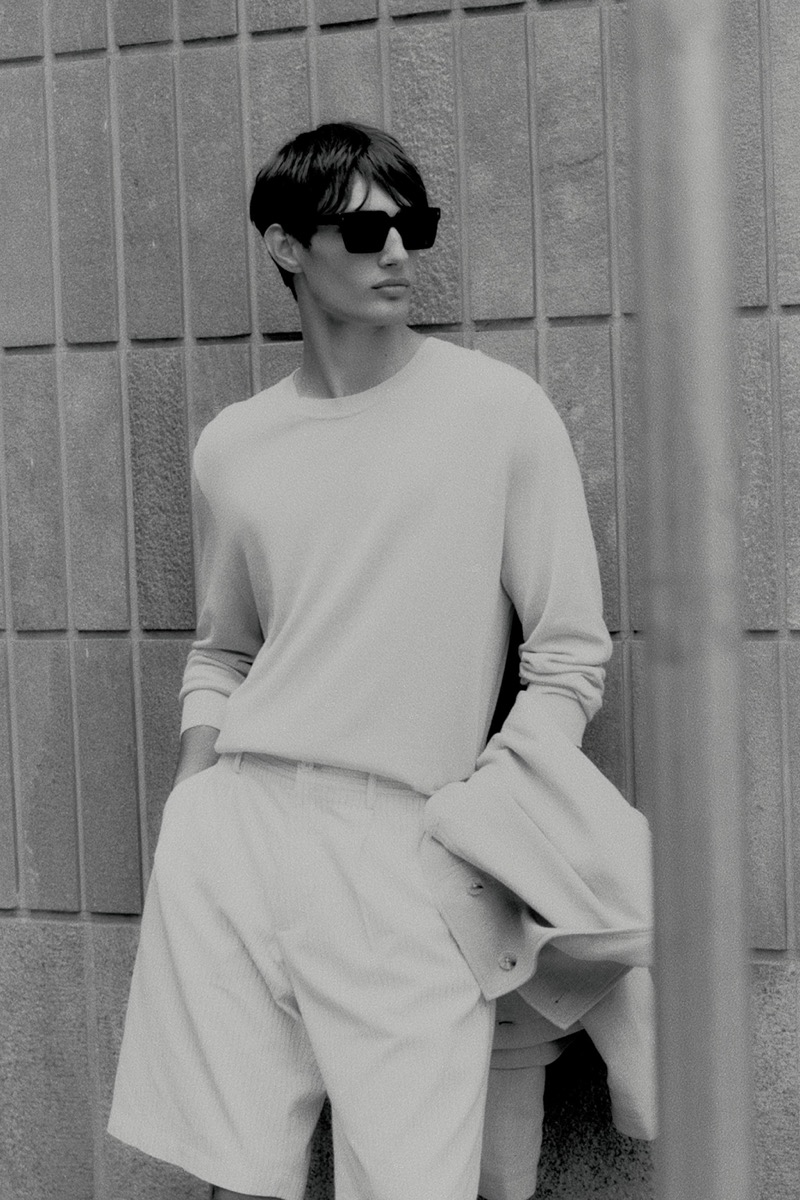 Thatcher Thornton models a lightweight crewneck sweater with striped shorts.