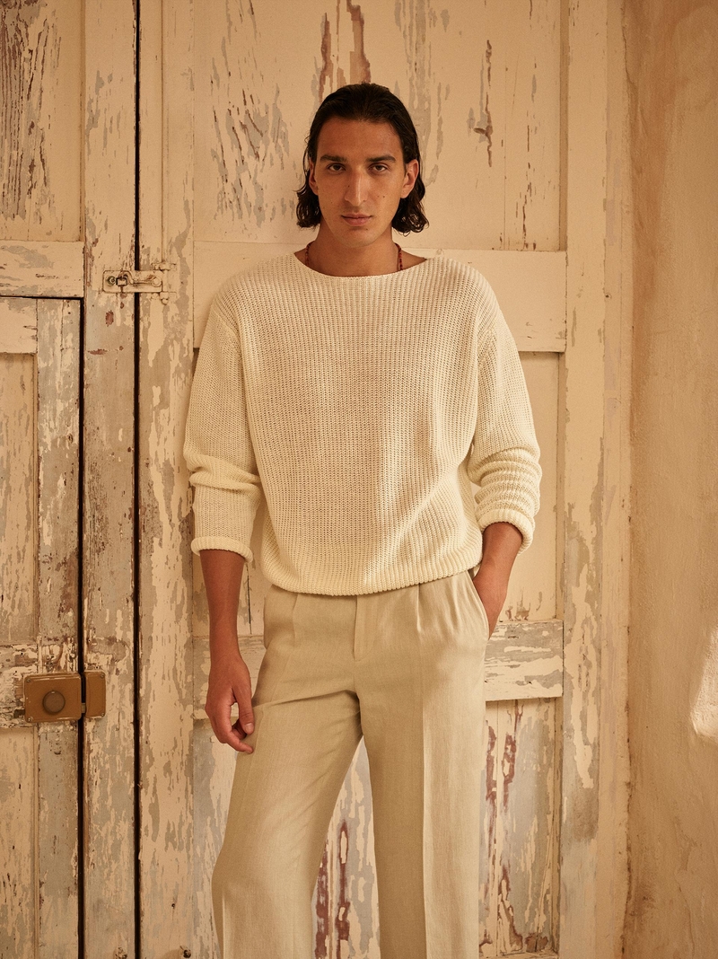 Yaz Yüceil models a cream knit sweater and relaxed trousers, displaying Zara Origins’ summer 2024 style.