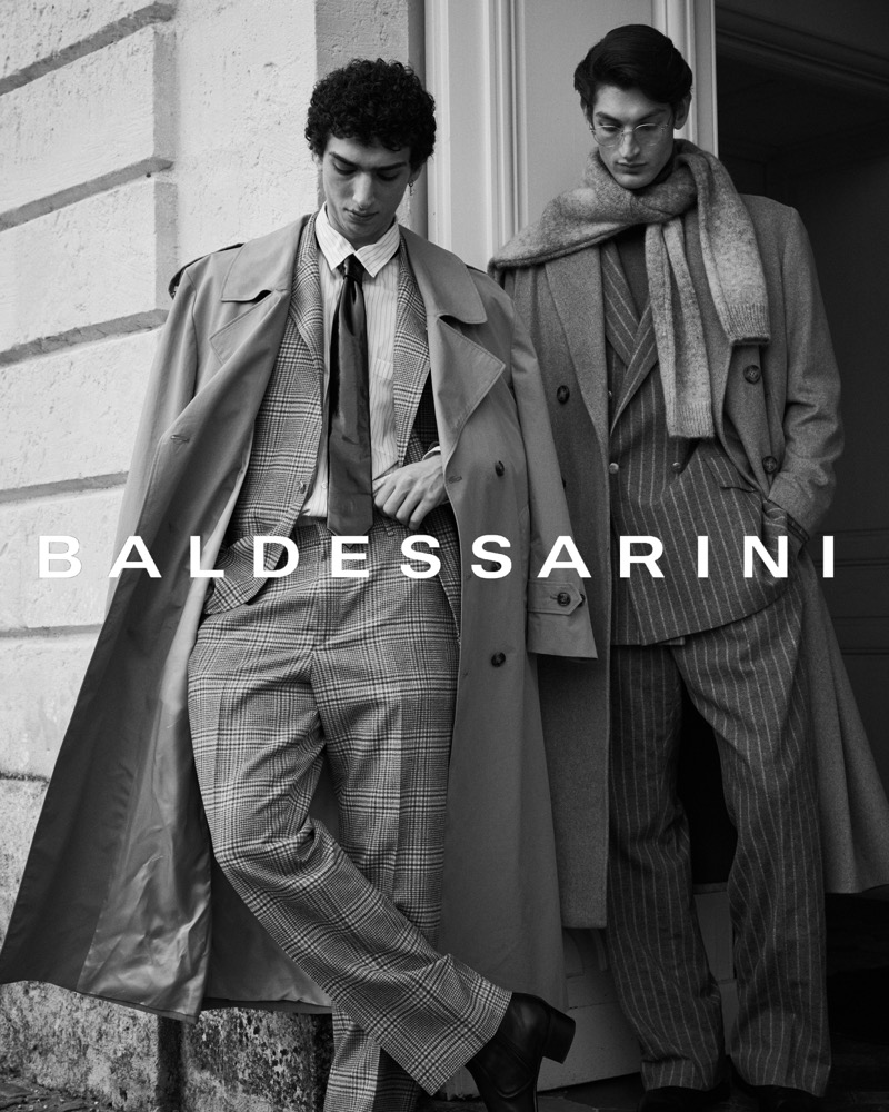 Models Qaher Harhash and Aaron Shandel front Baldessarini’s fall-winter 2024 campaign, wearing elegant suits and coats.