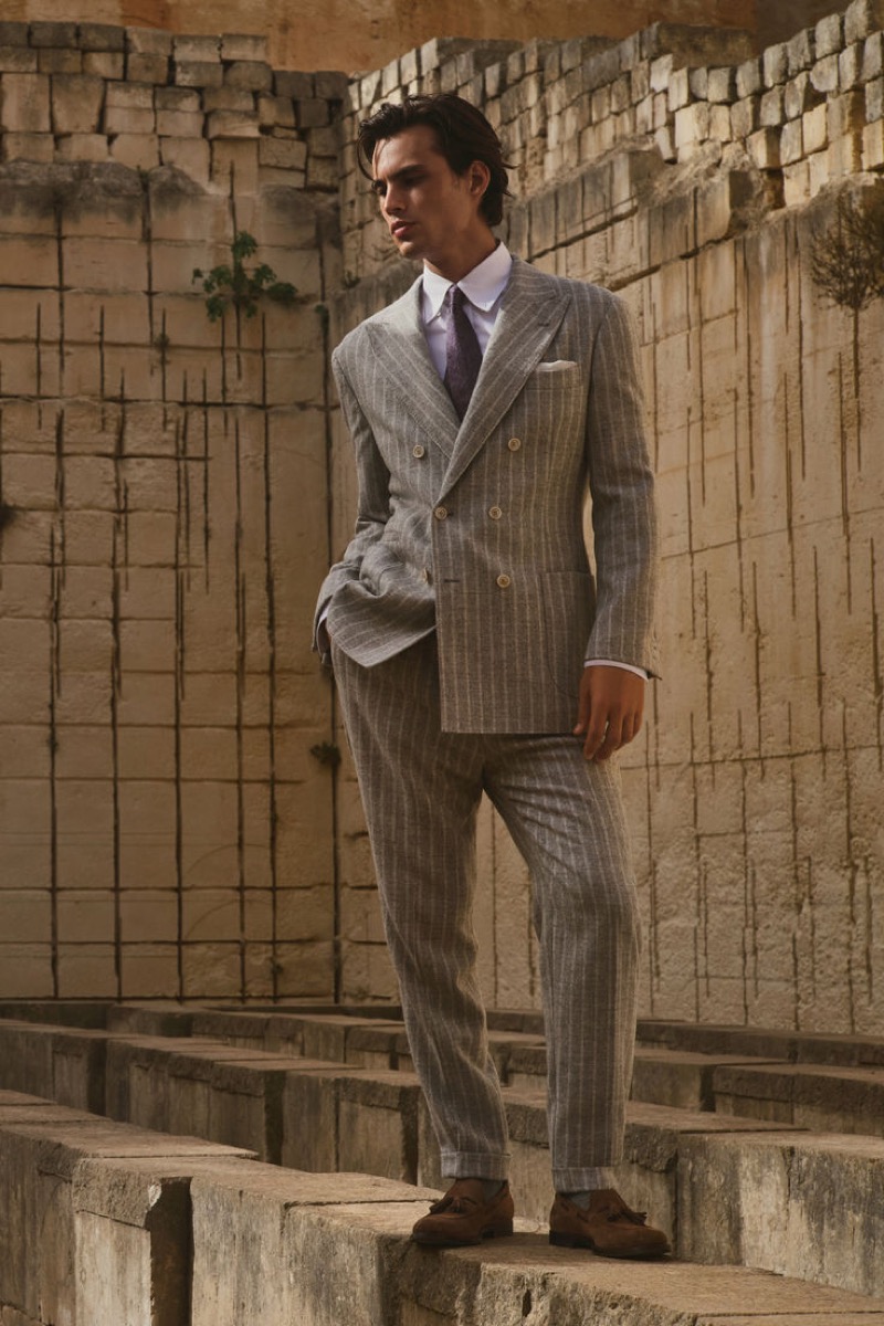 Louis Baines dons a grey, striped double-breasted suit from Brunello Cucinelli.