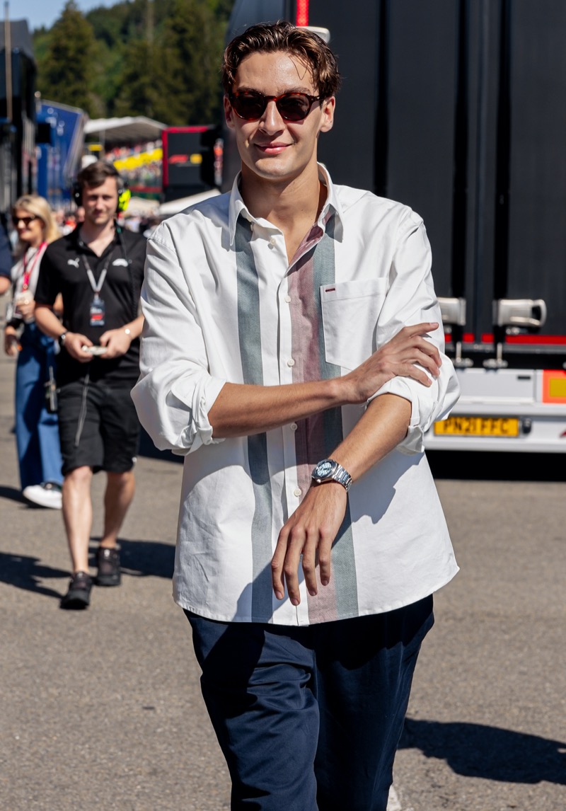 All smiles, George Russell wears a Tommy Hilfiger Oxford shirt at the Belgian Grand Prix.