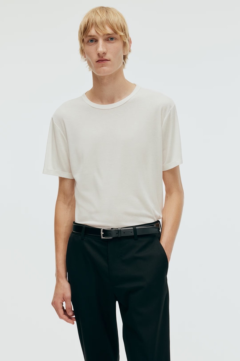 Pierrick Grégoire models a slim-fit white T-shirt with black trousers from H&M. 