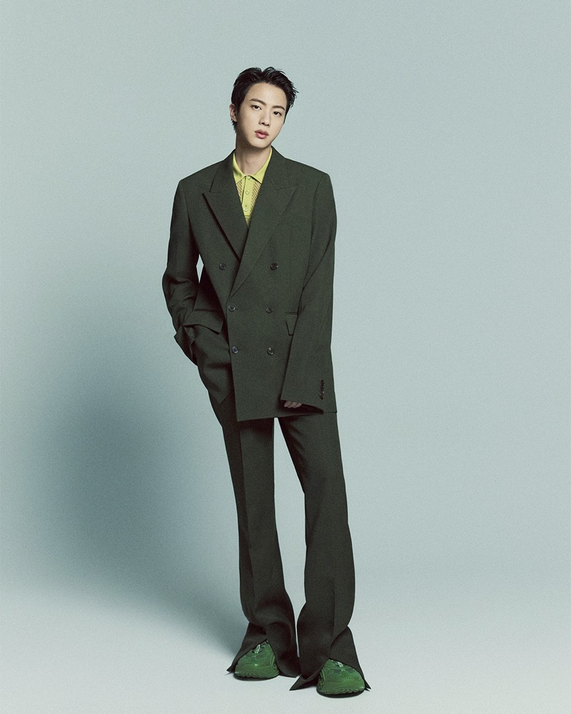 Jin dons a double-breasted Gucci suit with a lime green polo and green sneakers.