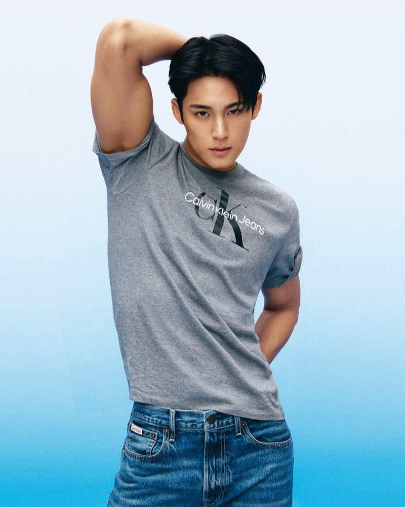 Going casual for Calvin Klein, MINGYU wears a grey logo tee with jeans for the brand’s fall 2024 campaign.