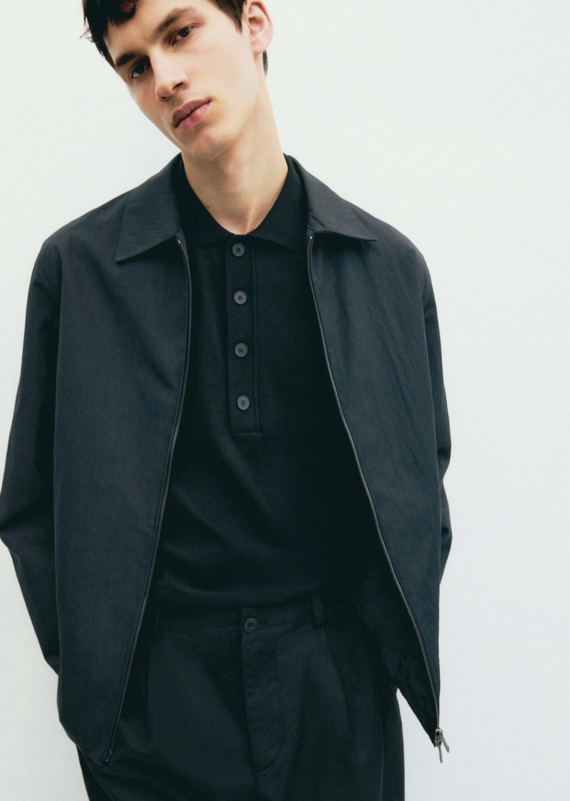 Model Kaplan Hani wears a monochromatic look featuring a sweater polo and blouson jacket. 