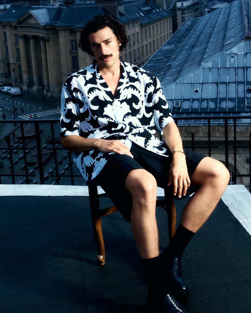 Embracing casual summer style, Giovanni Zattera wears a printed Valentino shirt with Alexander McQueen shorts. 