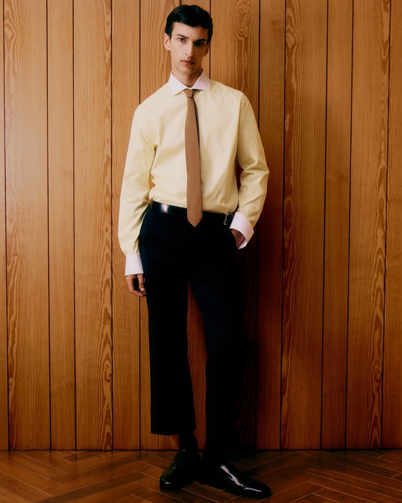 Habib Masovic wears a pale yellow shirt and trousers from Prada.