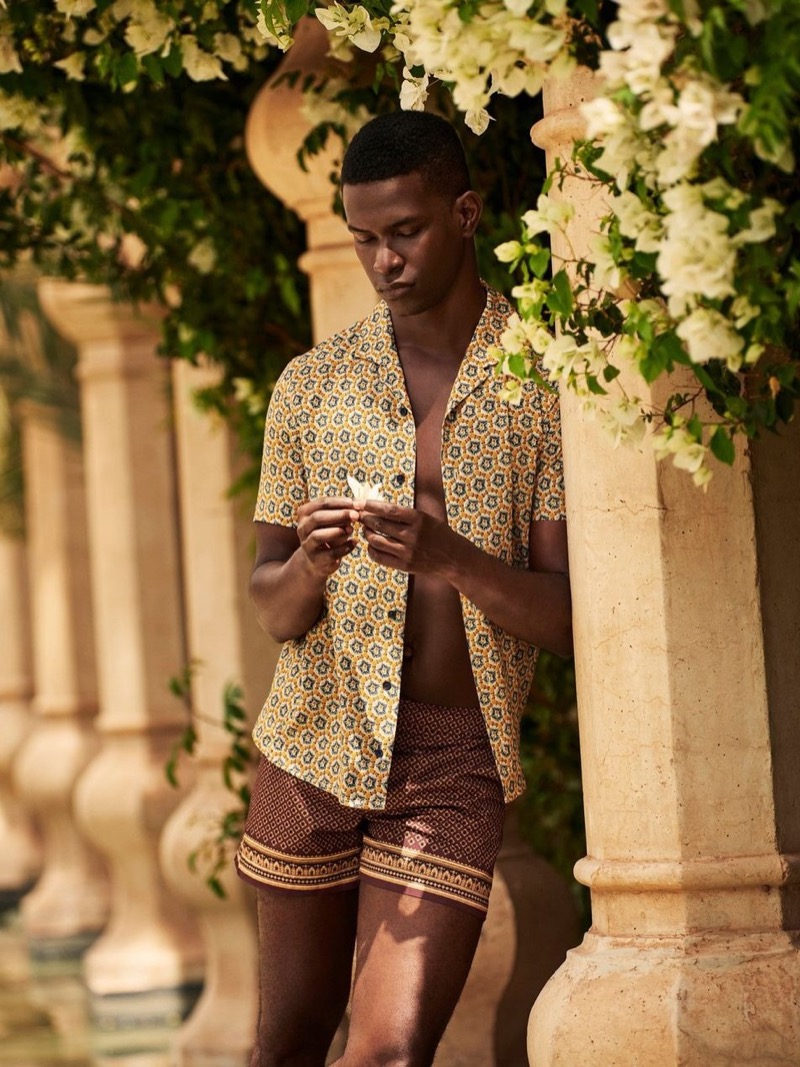 Salomon Diaz models a printed shirt and swim shorts from Orlebar Brown’s fall 2024 collection.