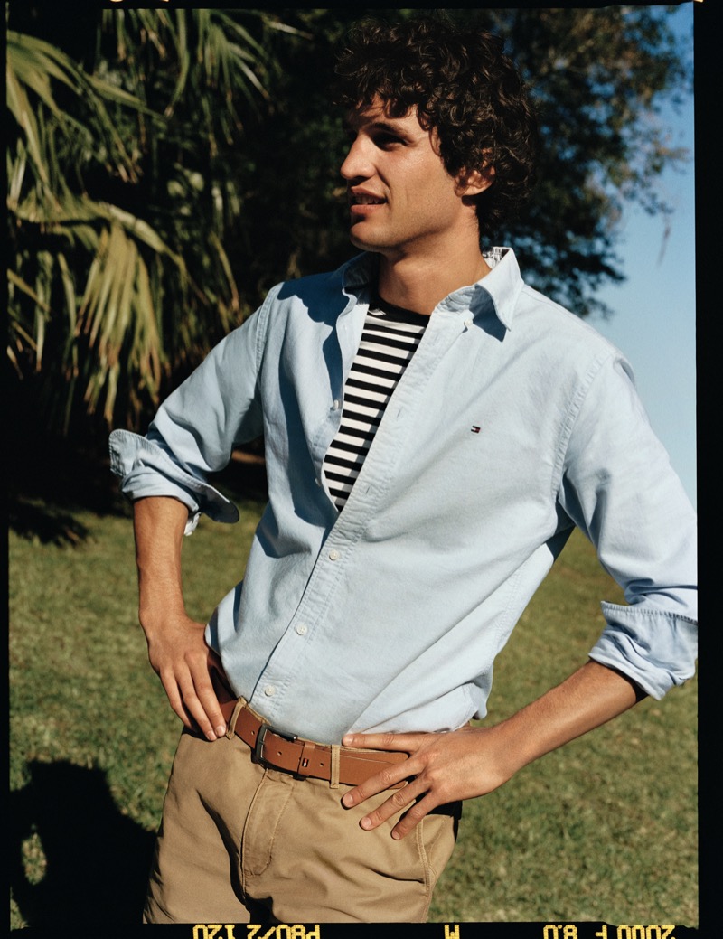 Francisco Henriques wears an Oxford shirt, striped tee, and khakis from Tommy Hilfiger’s pre-fall 2024 collection.