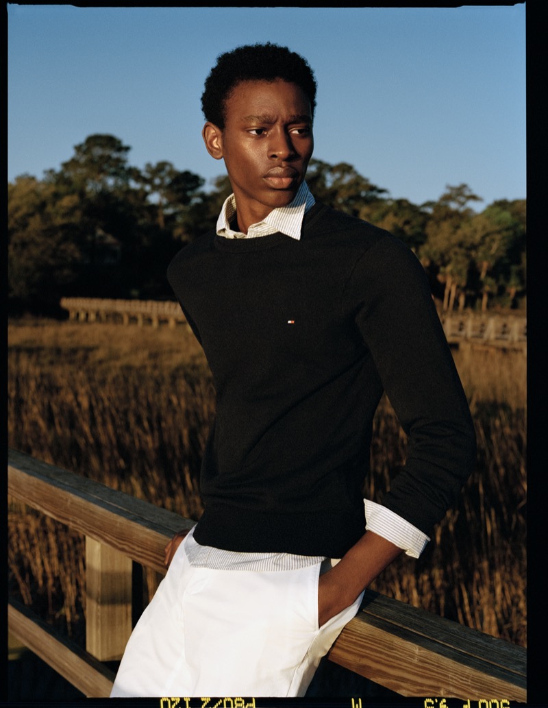 Adamu Bulus sports a crewneck sweater over a striped shirt for Tommy Hilfiger’s pre-fall 2024 campaign.