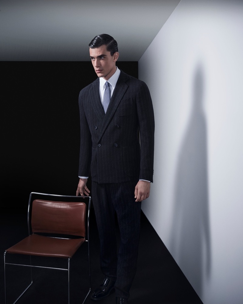 Model Xavier Serrano wears a pinstripe double-breasted suit for the Giorgio Armani Made to Measure fall-winter 2024 advertisement.