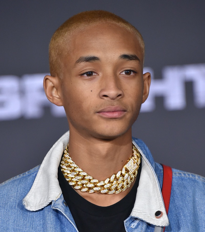 Jaden Smith’s bold blonde buzz cut creates a striking contrast, offering a modern and artistic twist on a classic style.