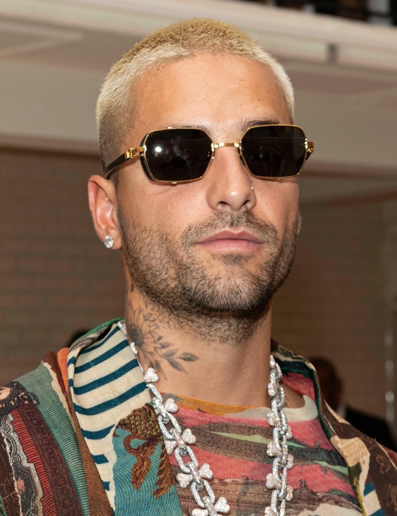 Maluma’s platinum blonde buzz cut steals the spotlight, balancing edgy style with high-fashion sophistication.