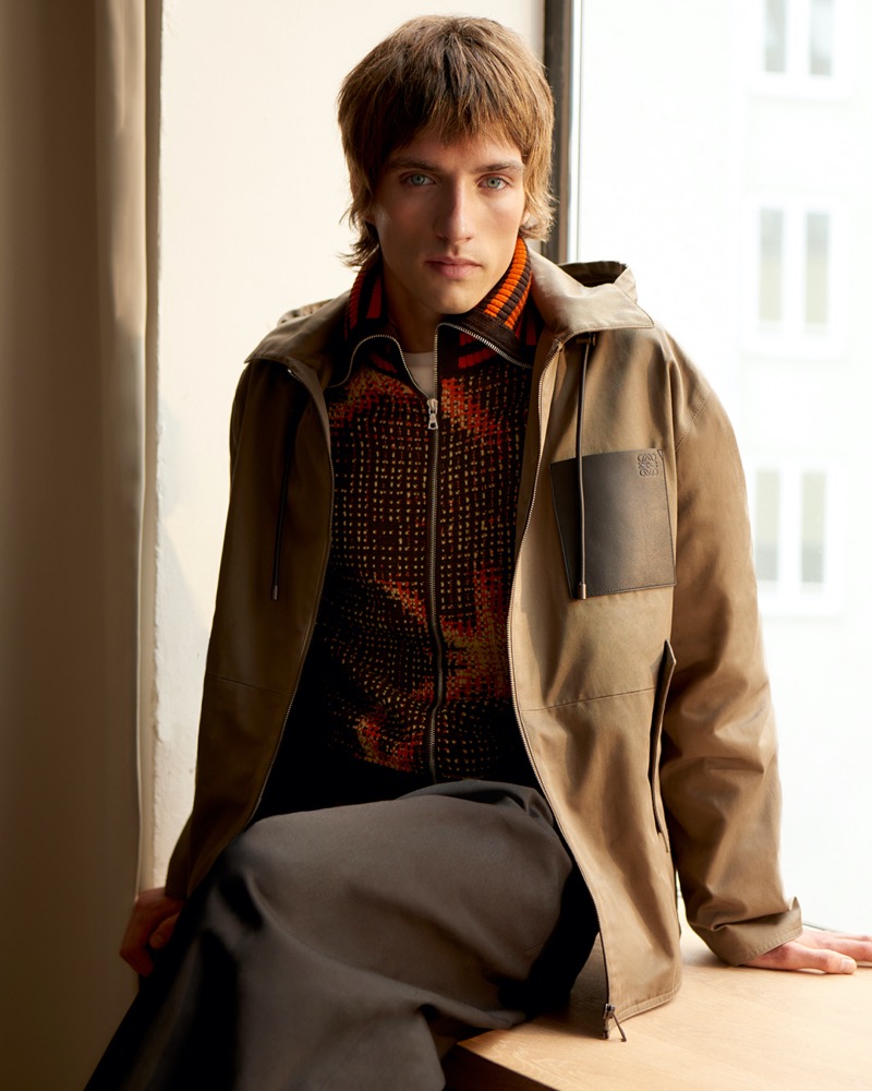 Connecting with Mytheresa, Samuel Curtis models a Dries Van Noten cardigan with a LOEWE jacket.