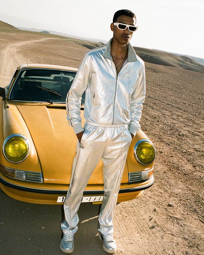 Mohamed Hassan rocks a silver tracksuit for Palm Angels’ fall-winter 2024 campaign.