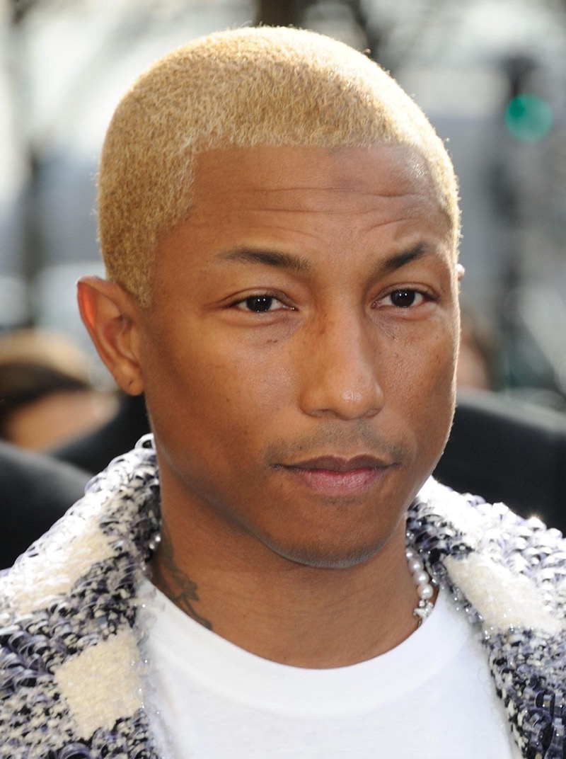 Pharrell Williams’ blonde buzz cut transforms tradition into a daring statement with its bold, vibrant hue.