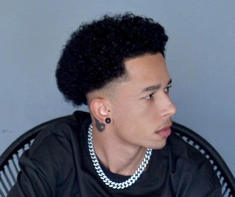 The short afro low skin fade offers a clean, tight fade accentuating facial features.