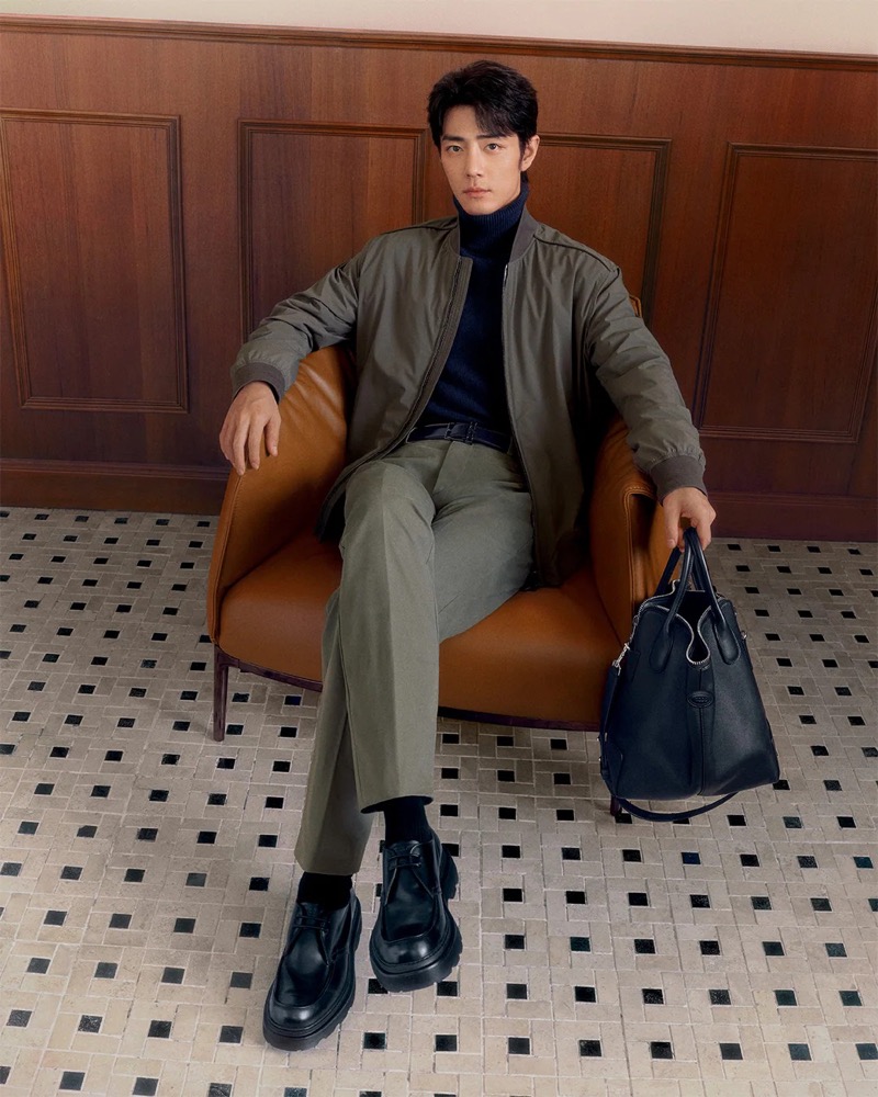 Sporting a bomber jacket, Xiao Zhan fronts Tod’s fall-winter 2024 advertisement.