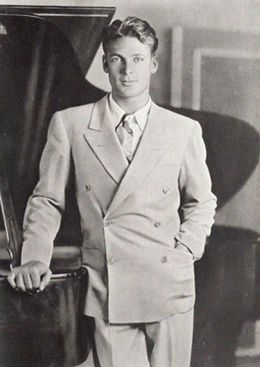 Charles Farrell wears the popular double-breasted suit of the 1930s. 