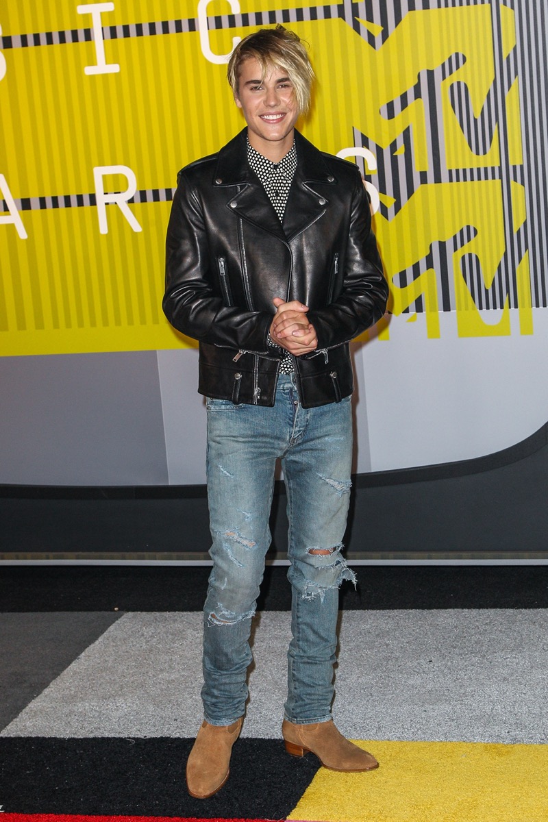 Justin Bieber encapsulates the 2010s with a popular look featuring a leather biker jacket, skinny jeans, and ankle boots.